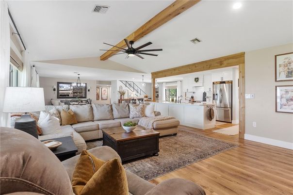 Chandelier, Dining room, Interior, Kitchen, Living room, Pendant Lights, Recessed Lighting, Stainless Steel Appliances, Wooden Beams, Wood Texture Flooring