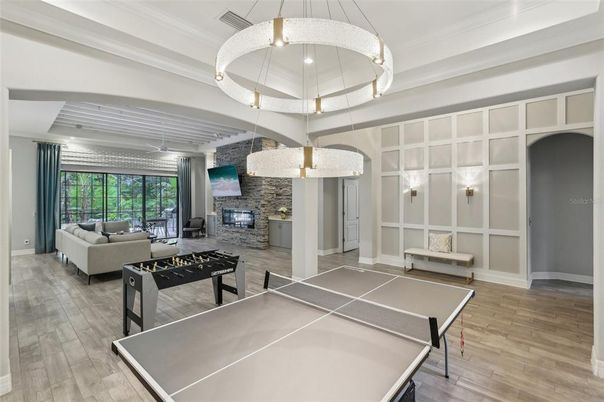 Fireplace, Game Room, Interior, Living room, Pendant Lights, Stone Walls, Wood Texture Flooring
