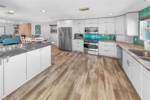 Dining room, Interior, Kitchen, Recessed Lighting, Stainless Steel Appliances, Stone Walls, Wood Texture Flooring