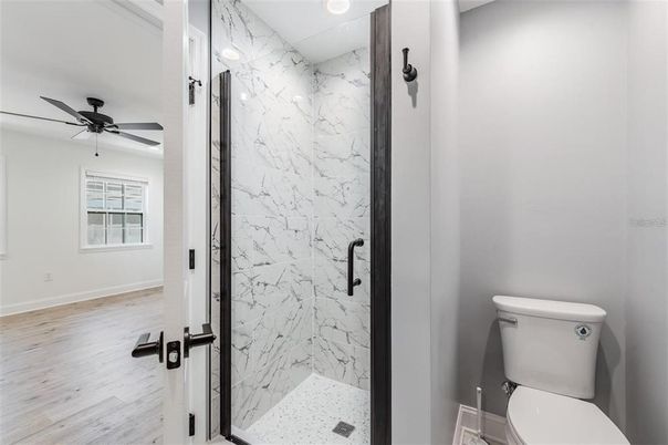 Bathroom, Glass Shower, Interior, Marble Walls, Recessed Lighting, Wood Texture Flooring