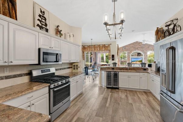 Fireplace, Interior, Kitchen, Pendant Lights, Stainless Steel Appliances, Stone Walls, Wood Texture Flooring