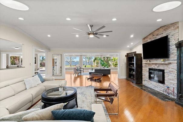 Fireplace, Interior, Living room, Piano, Recessed Lighting, Stone Walls, Wood Texture Flooring