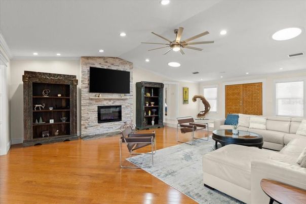 Fireplace, Interior, Living room, Recessed Lighting, Stone Walls, Wood Texture Flooring