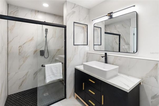 Bathroom, Dual Sink Vanities, Glass Shower, Interior, Marble Walls, Recessed Lighting