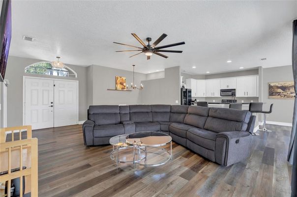 Chandelier, Dining room, Interior, Kitchen, Living room, Pendant Lights, Recessed Lighting, Stainless Steel Appliances, Wood Texture Flooring