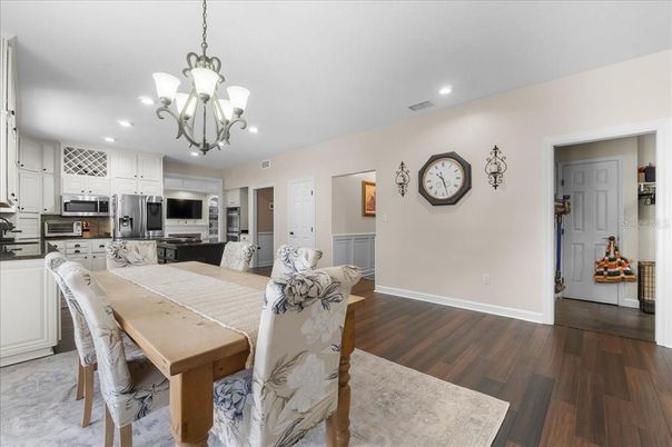 Chandelier, Dining room, Interior, Kitchen, Recessed Lighting, Stainless Steel Appliances, Wood Texture Flooring