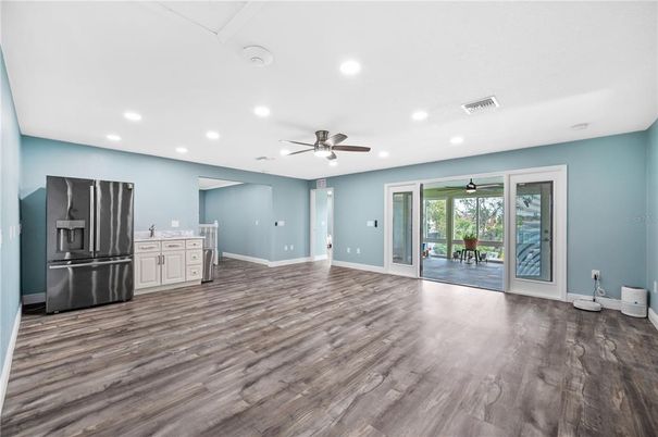 Empty room, Interior, Kitchen, Recessed Lighting, Stainless Steel Appliances, Wood Texture Flooring