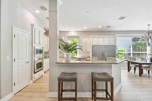 Dining room, Interior, Kitchen, Pendant Lights, Recessed Lighting, Stainless Steel Appliances, Wood Texture Flooring