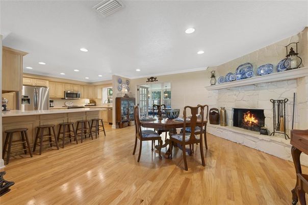 Dining room, Fireplace, Interior, Kitchen, Recessed Lighting, Stainless Steel Appliances, Wood Texture Flooring