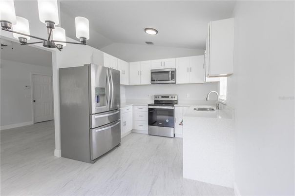 Interior, Kitchen, Marble, Recessed Lighting, Stainless Steel Appliances, Wood Texture Flooring