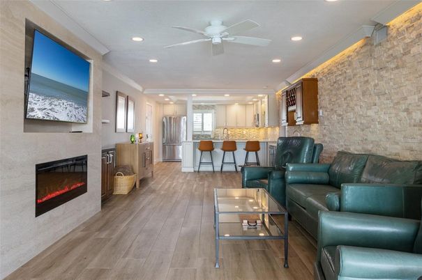 Fireplace, Interior, Kitchen, Living room, Recessed Lighting, Stainless Steel Appliances, Stone Walls, Wood Texture Flooring