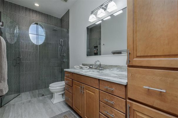 Bathroom, Dual Sink Vanities, Glass Shower, Interior, Recessed Lighting, Wood Texture Flooring