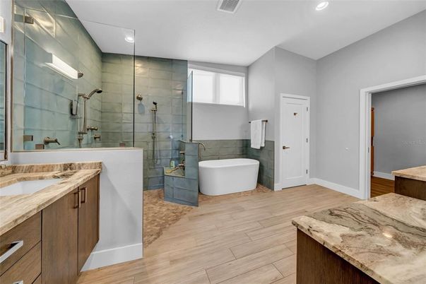 Bathroom, Dual Sink Vanities, Free Standing Baths, Glass Shower, Interior, Recessed Lighting, Wood Texture Flooring