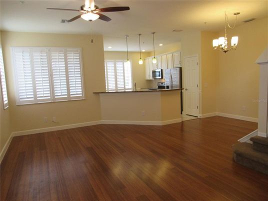 Chandelier, Empty room, Interior, Kitchen, Pendant Lights, Recessed Lighting, Stainless Steel Appliances, Wood Texture Flooring