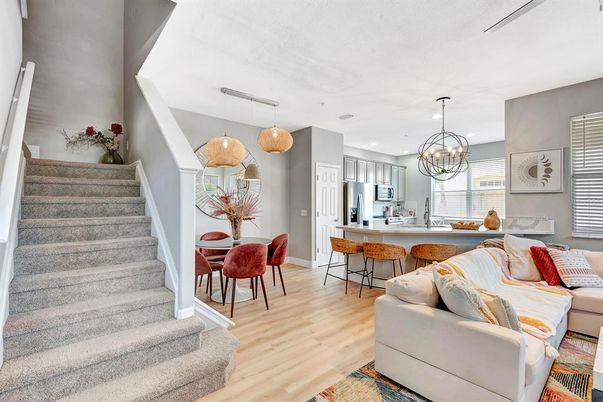 Chandelier, Dining room, Interior, Kitchen, Living room, Pendant Lights, Recessed Lighting, Stainless Steel Appliances, Wood Texture Flooring