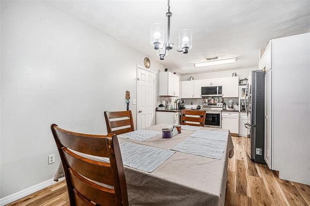 Chandelier, Dining room, Interior, Kitchen, Stainless Steel Appliances, Wood Texture Flooring