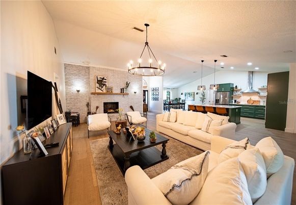 Chandelier, Dining room, Fireplace, Interior, Kitchen, Living room, Pendant Lights, Recessed Lighting, Stone Walls, Wood Texture Flooring