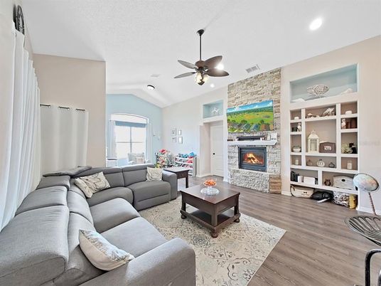 Fireplace, Interior, Living room, Recessed Lighting, Stone Walls, Wood Texture Flooring
