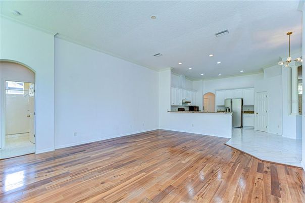 Empty room, Interior, Kitchen, Pendant Lights, Recessed Lighting, Stainless Steel Appliances, Wood Texture Flooring