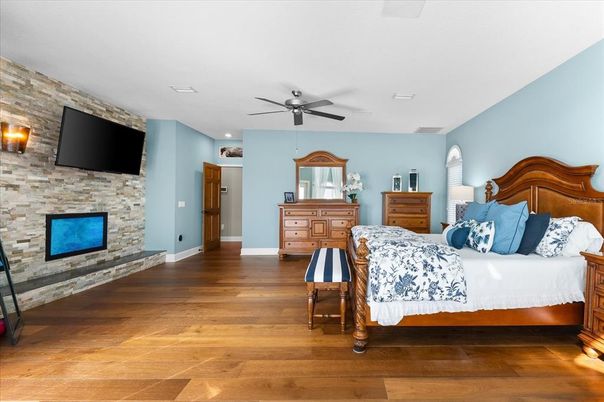 Bedroom, Fireplace, Interior, Recessed Lighting, Stone Walls, Wood Texture Flooring