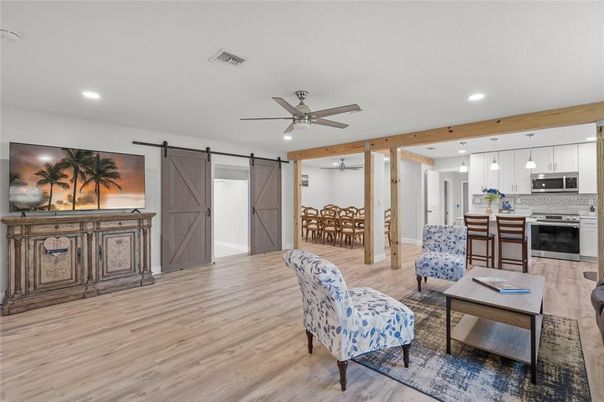 Dining room, Interior, Kitchen, Living room, Pendant Lights, Recessed Lighting, Stainless Steel Appliances, Wooden Beams, Wood Texture Flooring
