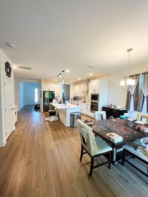 Chandelier, Dining room, Interior, Kitchen, Pendant Lights, Recessed Lighting, Stainless Steel Appliances, Wood Texture Flooring