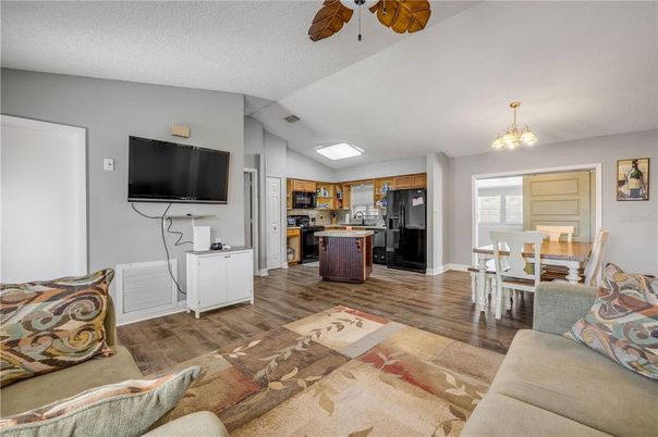 Chandelier, Dining room, Interior, Kitchen, Living room, Stainless Steel Appliances, Wood Texture Flooring