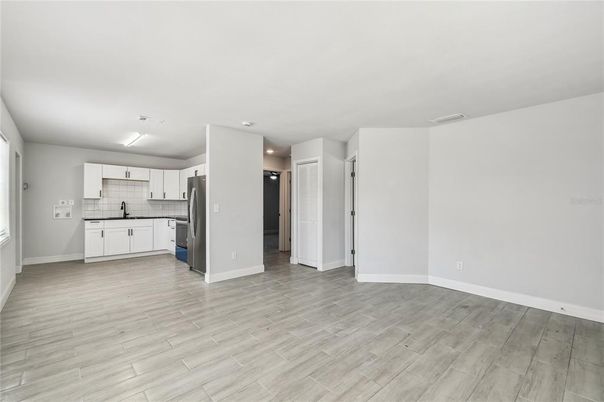 Empty room, Interior, Kitchen, Stainless Steel Appliances, Wood Texture Flooring