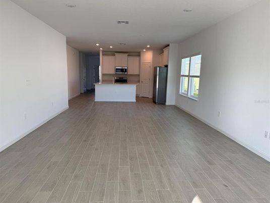 Empty room, Interior, Kitchen, Recessed Lighting, Stainless Steel Appliances, Wood Texture Flooring