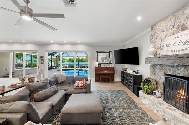 Fireplace, Interior, Living room, Piano, Recessed Lighting, Stone Walls, Wood Texture Flooring