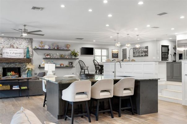 Fireplace, Interior, Kitchen, Living room, Pendant Lights, Recessed Lighting, Stainless Steel Appliances, Wood Texture Flooring