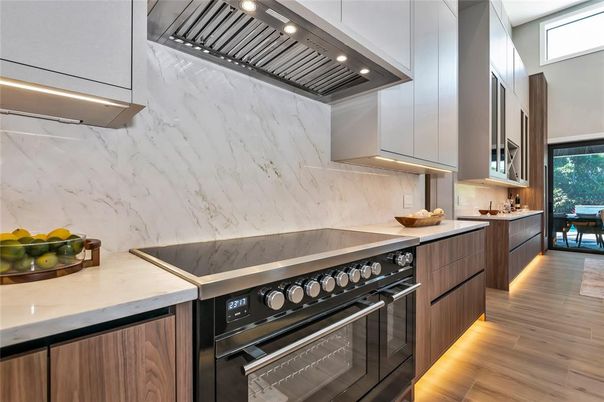 Interior, Kitchen, Marble Walls, Recessed Lighting, Stainless Steel Appliances, Wood Texture Flooring