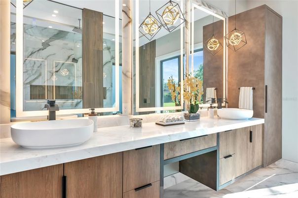 Bathroom, Dual Sink Vanities, Glass Shower, Interior, Marble, Marble Walls, Pendant Lights, Recessed Lighting