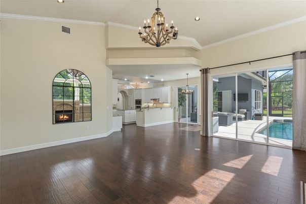Chandelier, Dining room, Fireplace, Interior, Kitchen, Pendant Lights, Pool, Recessed Lighting, Wood Texture Flooring