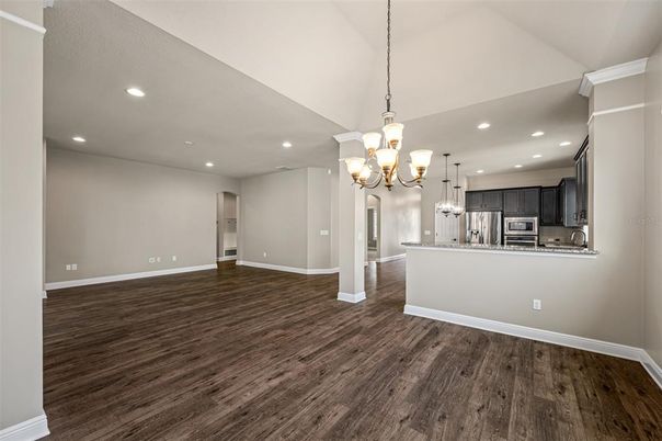 Chandelier, Empty room, Interior, Kitchen, Recessed Lighting, Stainless Steel Appliances, Wood Texture Flooring