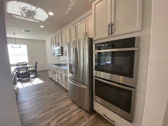 Dining room, Interior, Kitchen, Recessed Lighting, Stainless Steel Appliances, Wood Texture Flooring