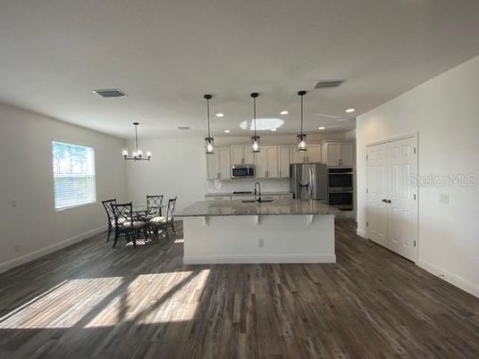 Chandelier, Dining room, Interior, Kitchen, Pendant Lights, Recessed Lighting, Stainless Steel Appliances, Wood Texture Flooring