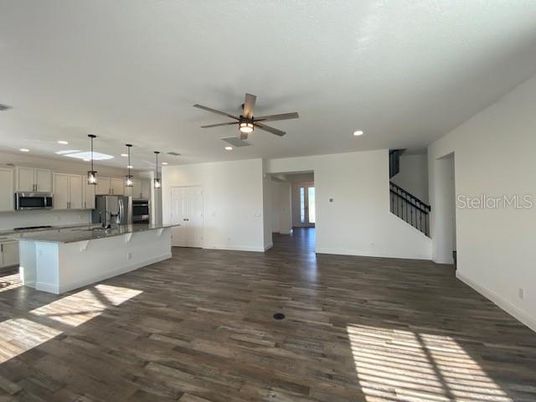 Empty room, Interior, Kitchen, Pendant Lights, Recessed Lighting, Stainless Steel Appliances, Wood Texture Flooring