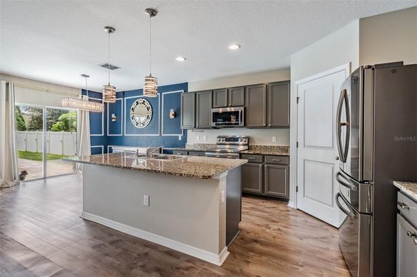 Chandelier, Interior, Kitchen, Pendant Lights, Recessed Lighting, Stainless Steel Appliances, Wood Texture Flooring