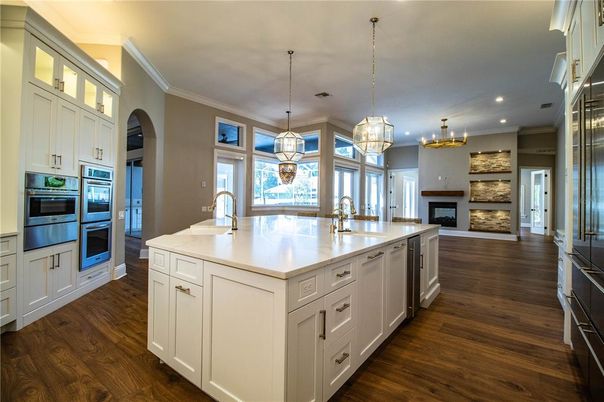 Chandelier, Fireplace, Interior, Kitchen, Pendant Lights, Recessed Lighting, Stainless Steel Appliances, Wood Texture Flooring
