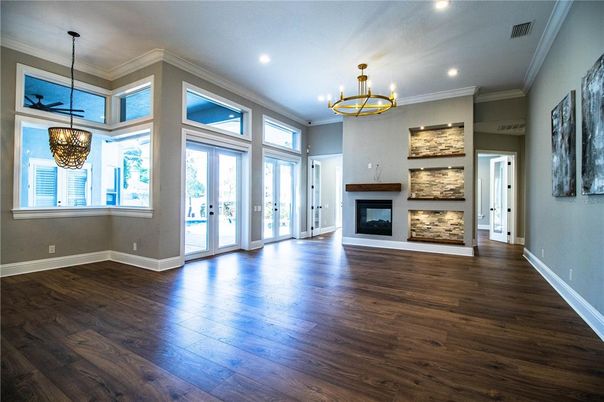 Chandelier, Empty room, Fireplace, Interior, Pendant Lights, Recessed Lighting, Wood Texture Flooring