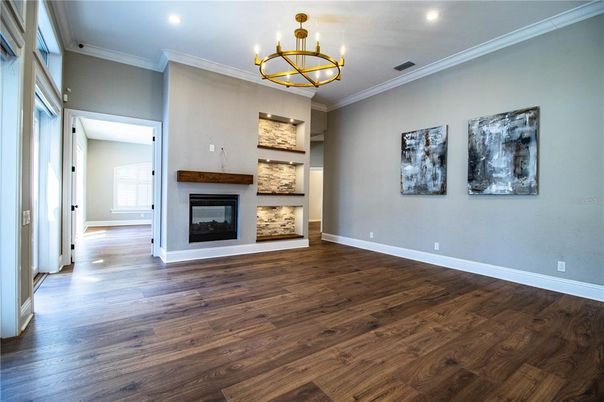 Chandelier, Empty room, Fireplace, Interior, Recessed Lighting, Wood Texture Flooring
