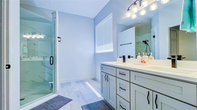 Bathroom, Dual Sink Vanities, Glass Shower, Interior, Marble Walls, Wood Texture Flooring