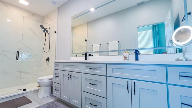 Bathroom, Dual Sink Vanities, Glass Shower, Interior, Marble Walls, Recessed Lighting