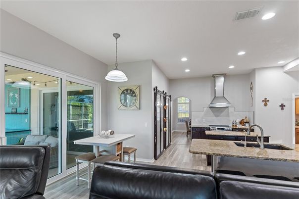 Dining room, Interior, Kitchen, Pendant Lights, Recessed Lighting, Stainless Steel Appliances, Wood Texture Flooring