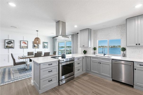 Dining room, Interior, Kitchen, Pendant Lights, Recessed Lighting, Stainless Steel Appliances, Water, Wood Texture Flooring