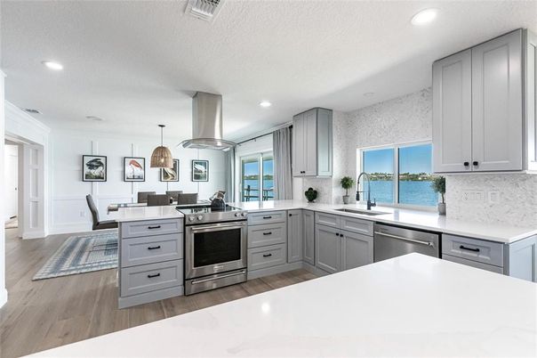 Dining room, Interior, Kitchen, Pendant Lights, Recessed Lighting, Stainless Steel Appliances, Water, Wood Texture Flooring
