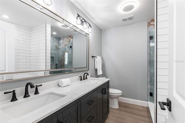 Bathroom, Dual Sink Vanities, Glass Shower, Interior, Recessed Lighting, Wood Texture Flooring