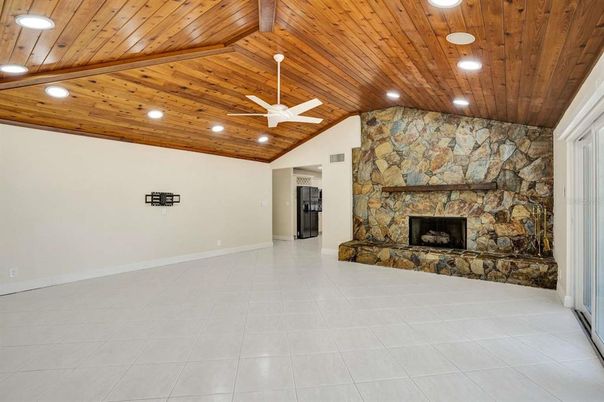 Empty room, Fireplace, Interior, Recessed Lighting, Stone Walls, Wooden Ceilings