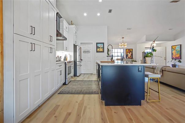 Chandelier, Interior, Kitchen, Living room, Recessed Lighting, Stainless Steel Appliances, Wood Texture Flooring